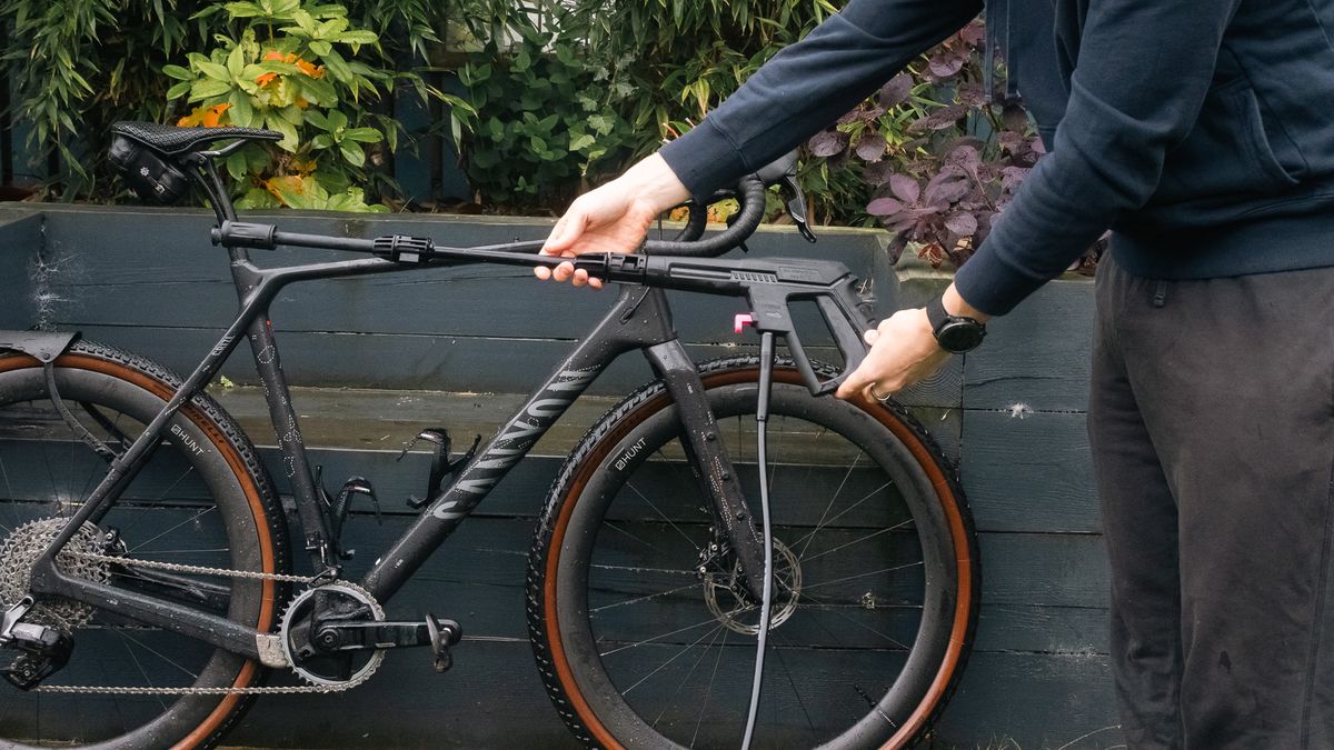 View of the Muc-Off Mobile Bike Pressure Washer lance with a Canyon bike behind.