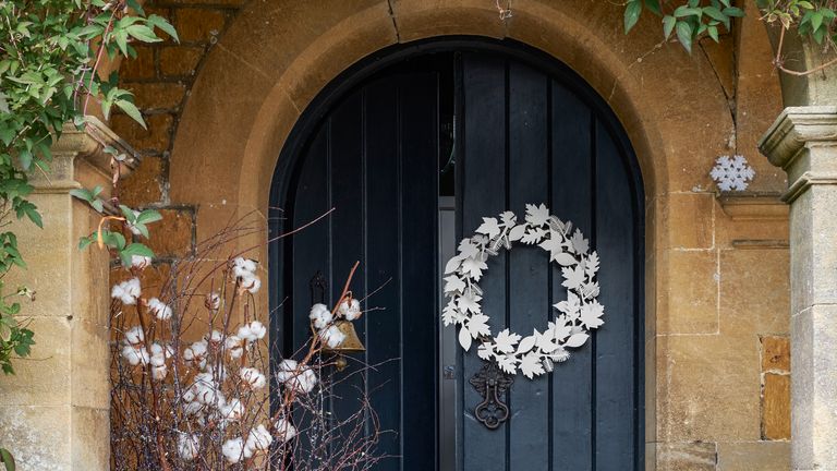 Christmas door decor with white metal wreath
