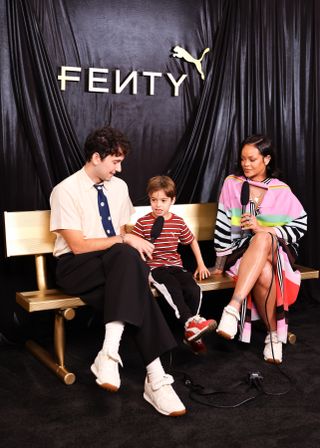 Rihanna doing an interview while wearing a Christopher John Rogers striped polo dress and a pair of sneakers