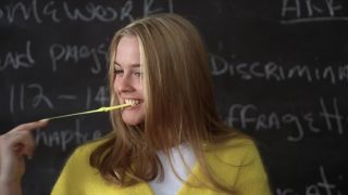 Cher stretching her gum while smiling in Clueless