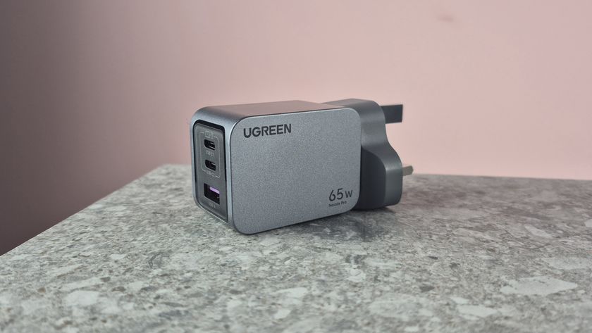 UGreen Nexode Pro 65W 3-Port Charger on stone surface against pink background