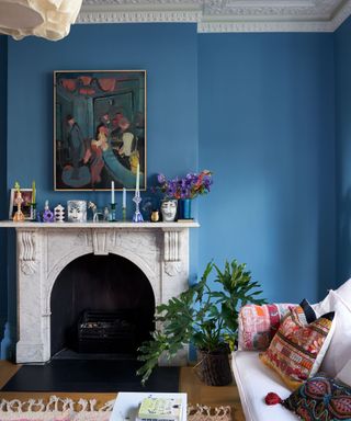 living room with fireplace and sofa with mid-blue walls