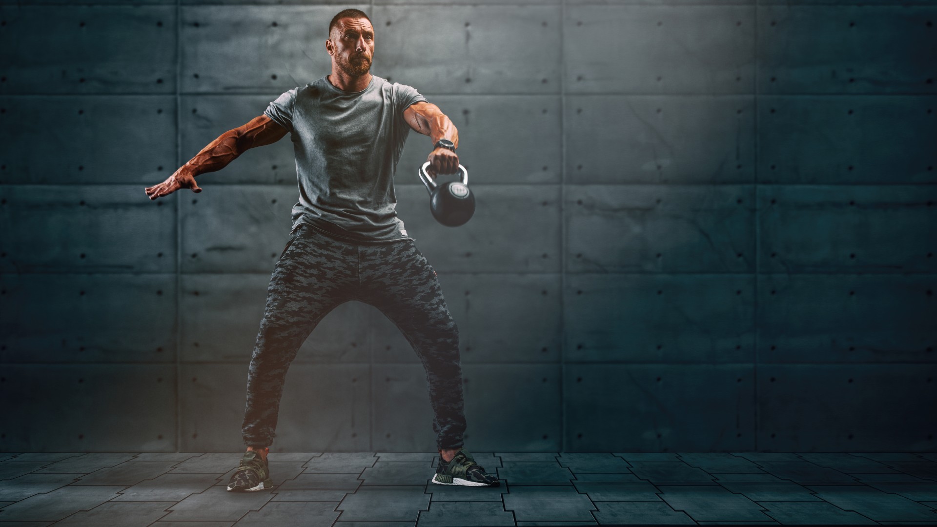Man swinging a kettlebell during a kettlebell leg workout