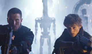 Terminator: Salvation John Connor and Kyle Reese aiming guns in a robot factory