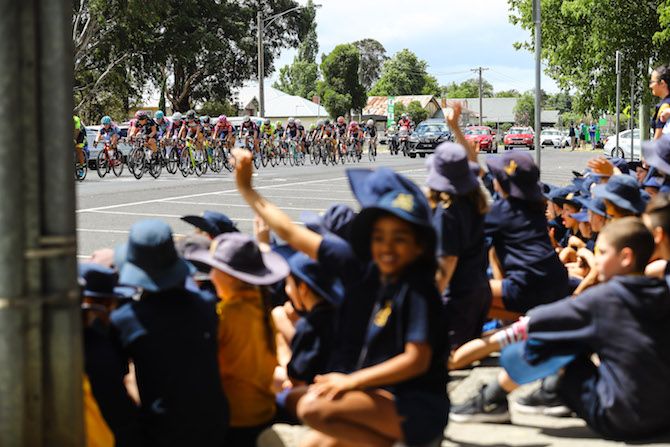 School children enjoy the spectacle of the Women's Herald Sun Tour going by