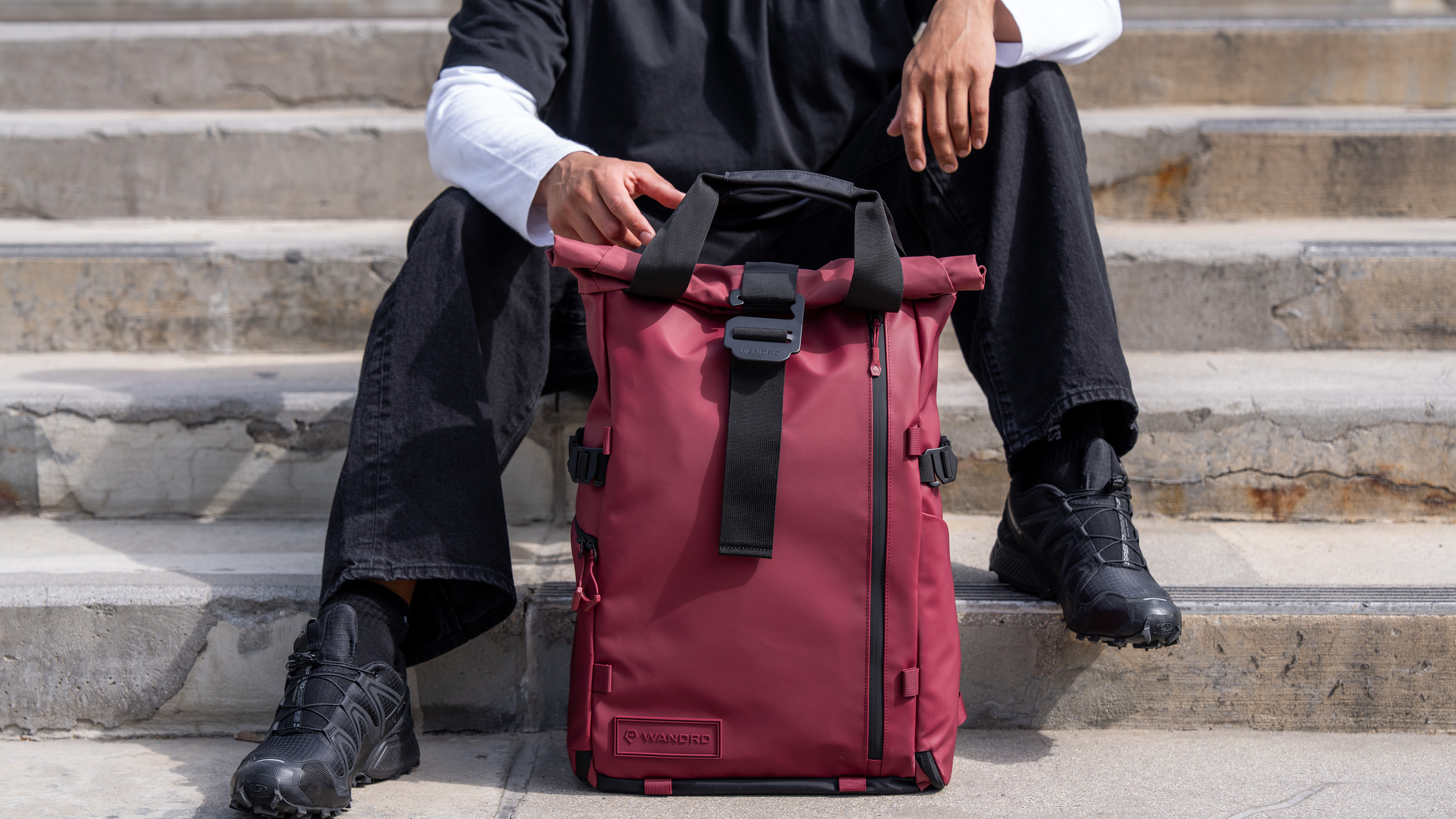 The Wandrd Prvke camera backpack in front of a person on stairs