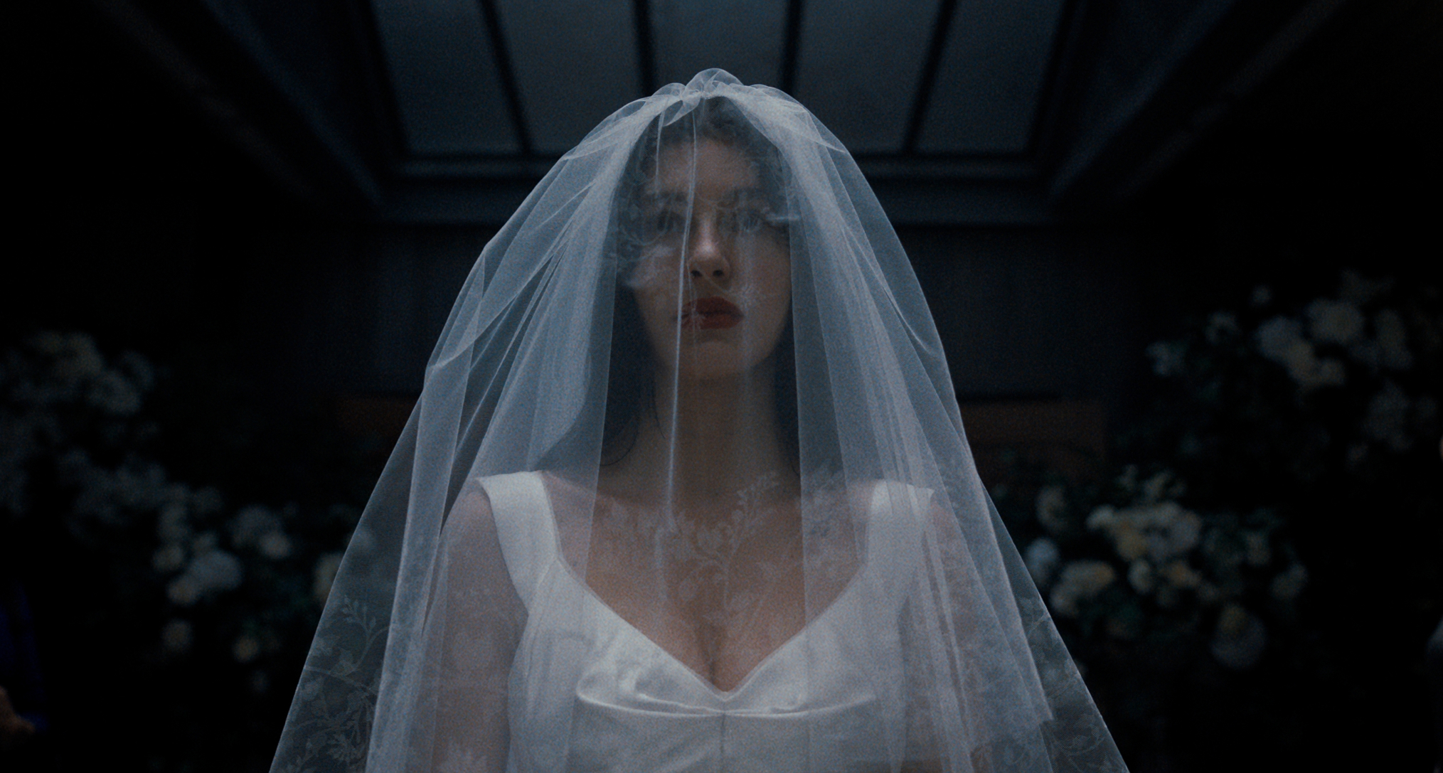 camila morrone in something very bad is going to happen wearing a white veil and wedding dress walking down the aisle in the finale