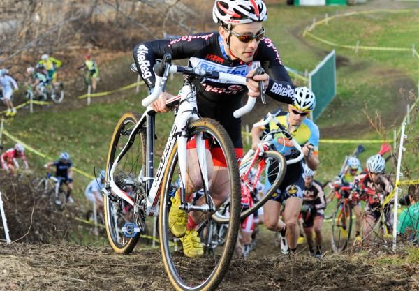 Justin Lindine carries his bike uphill.