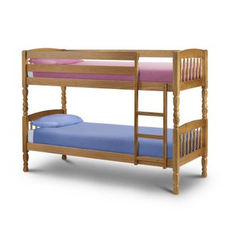 Pine bunk bed with fixed ladder and pink and blue bedding respectively
