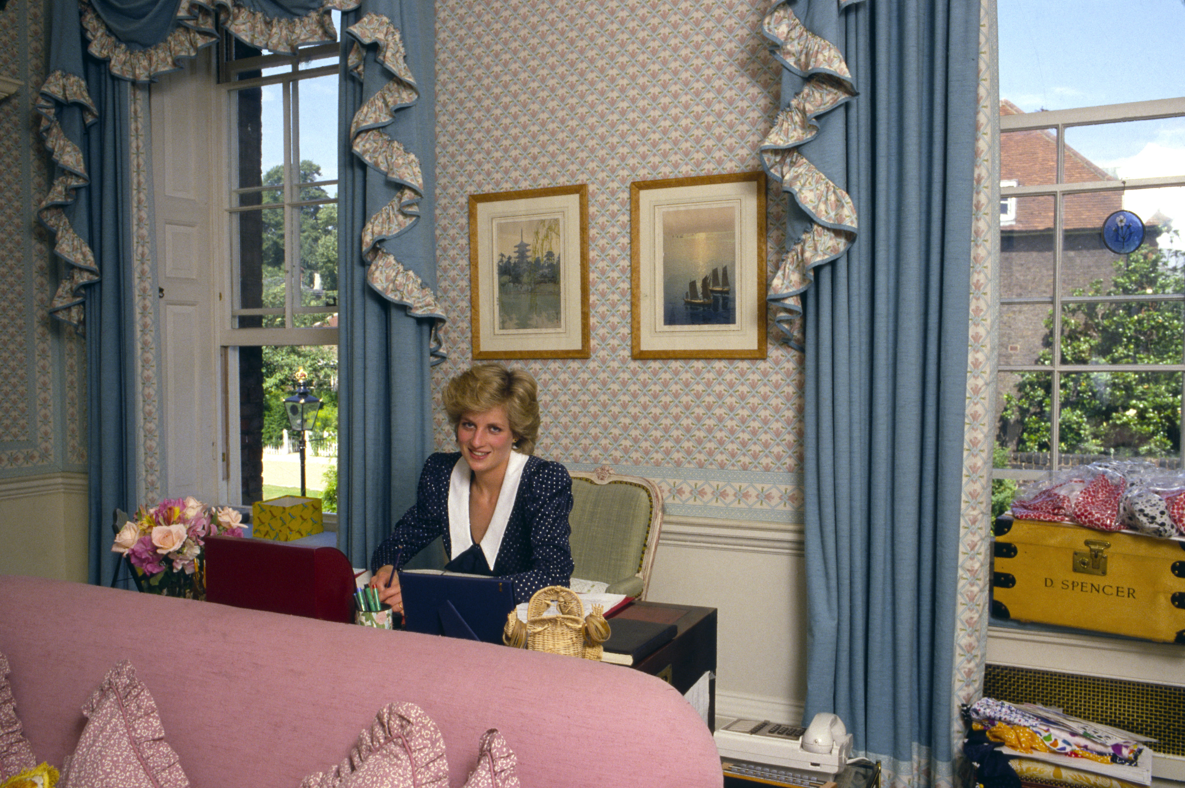 LONDON, UNITED KINGDOM - OCTOBER 06: Princess Diana At Her Desk In Her Sitting Room At Home In Kensington Palace, London. Beside Her Is Her School Tuckbox With The Name D.spencer. (Photo by Tim Graham Photo Library via Getty Images)