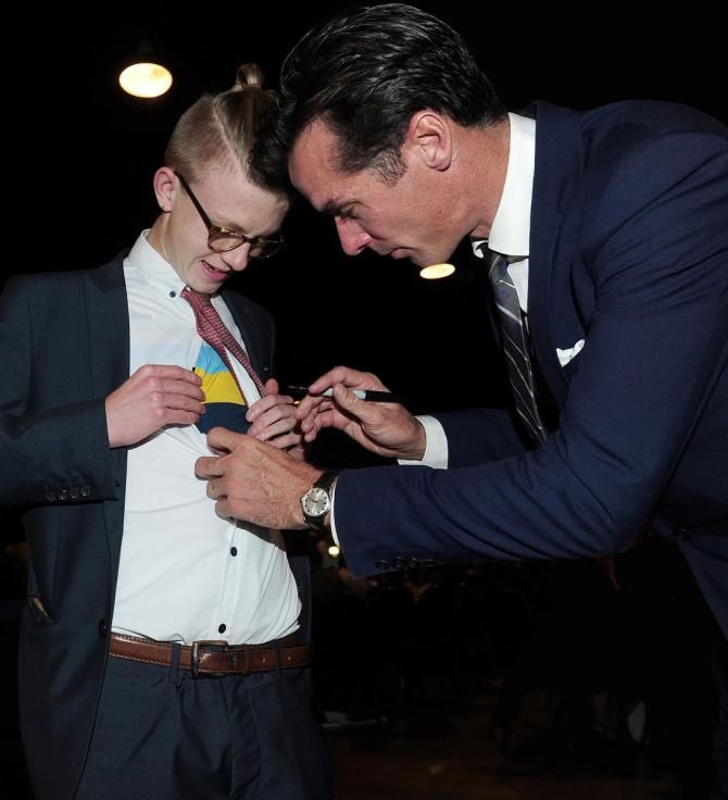 David Millar takes time to sign jerseys for the fans