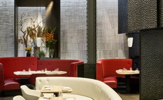 One Aldwych London, UK restaurant room with red seating sofa