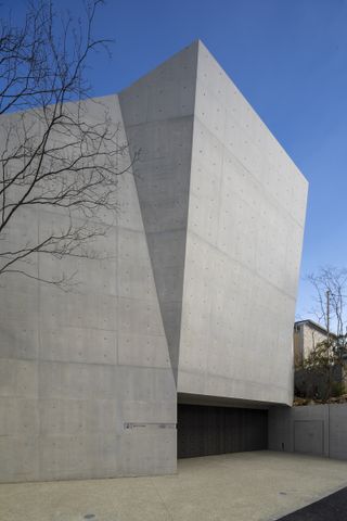 Front facade close up of modern concrete japanese house by maniera architects