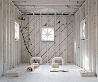 White yoga studio with wooden panels and mats