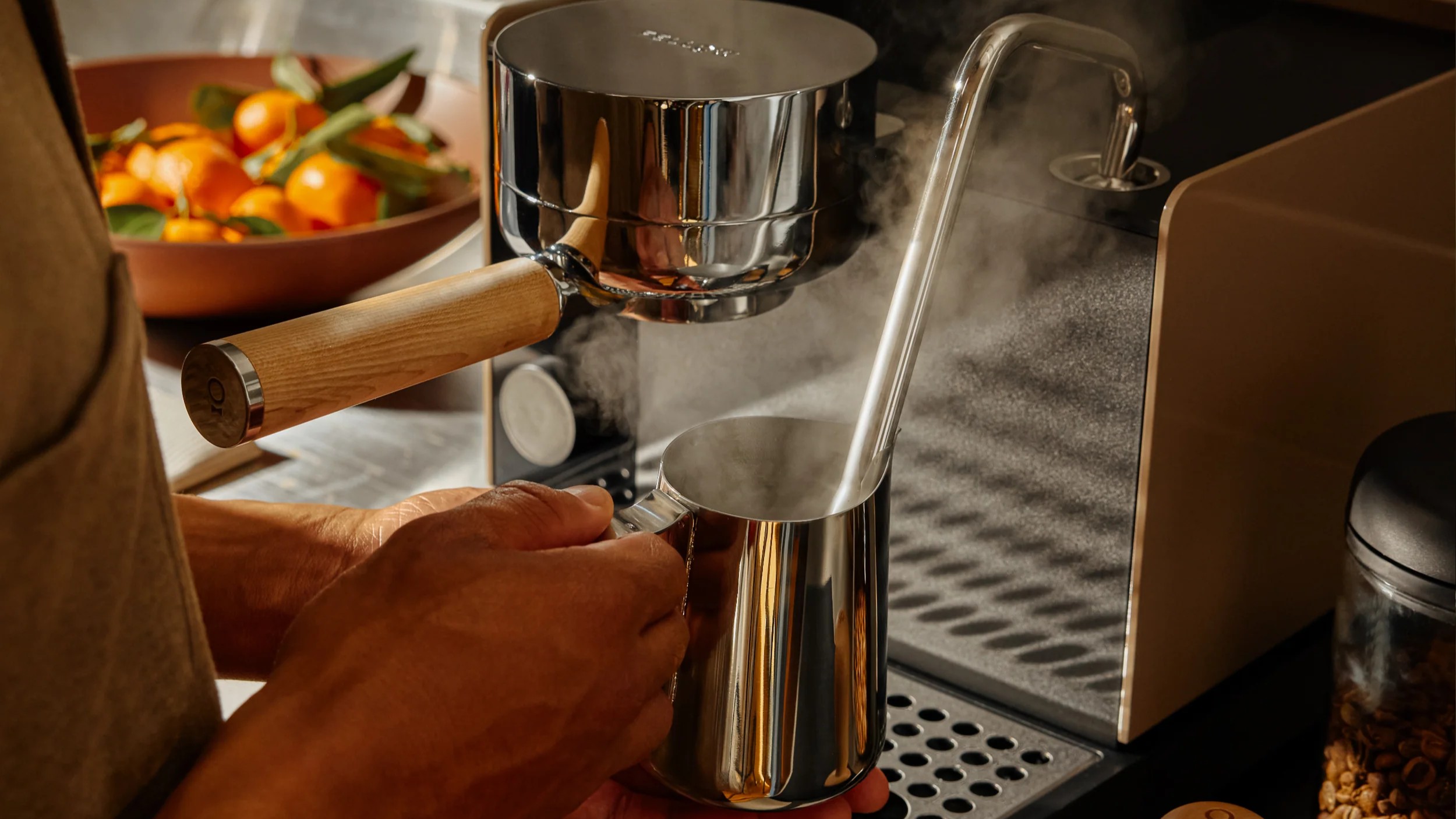 Person using Fellow Espresso Series 1 coffee machine to steam milk