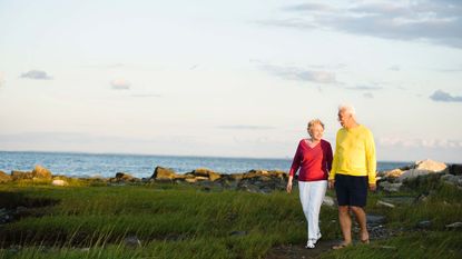 Senior couple walking along the Connecticut coastline