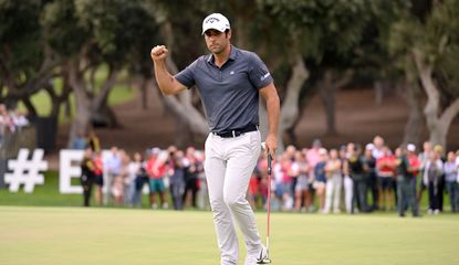 Otaugui waves to the crowd after holing the winning putt