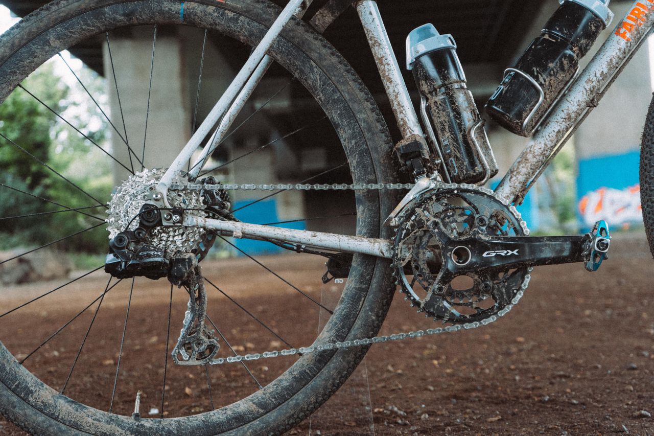 A muddy gravel bike in an underpass
