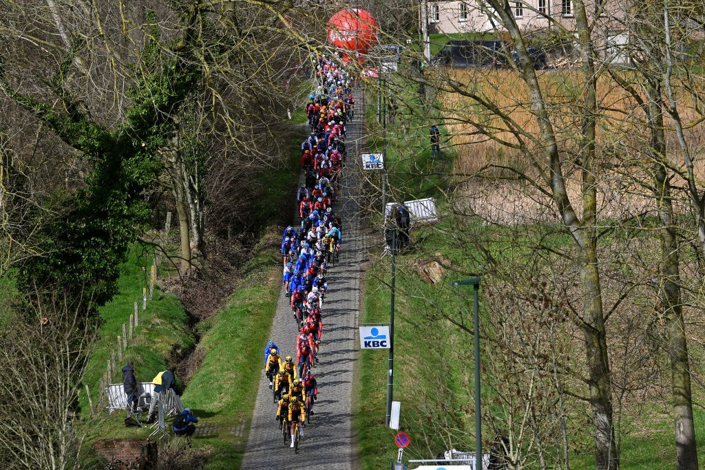 NINOVE BELGIUM FEBRUARY 25 A general view of the peloton passing through a Haaghoek cobblestones sector during the 78th Omloop Het Nieuwsblad Elite 2023 Mens Elite a 2073km one day race from Ghent to Ninove OHN23 on February 25 2023 in Ninove Belgium Photo by Luc ClaessenGetty Images