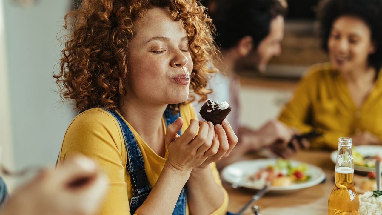 Woman enjoys tucking into indulgent food