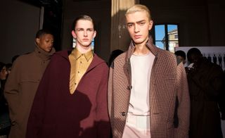 Two male models wearing clothing by Salvatore Ferragamo.