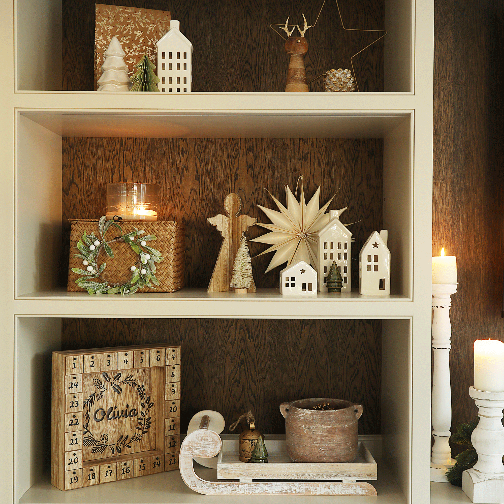 a bookcase decorated for Christmas