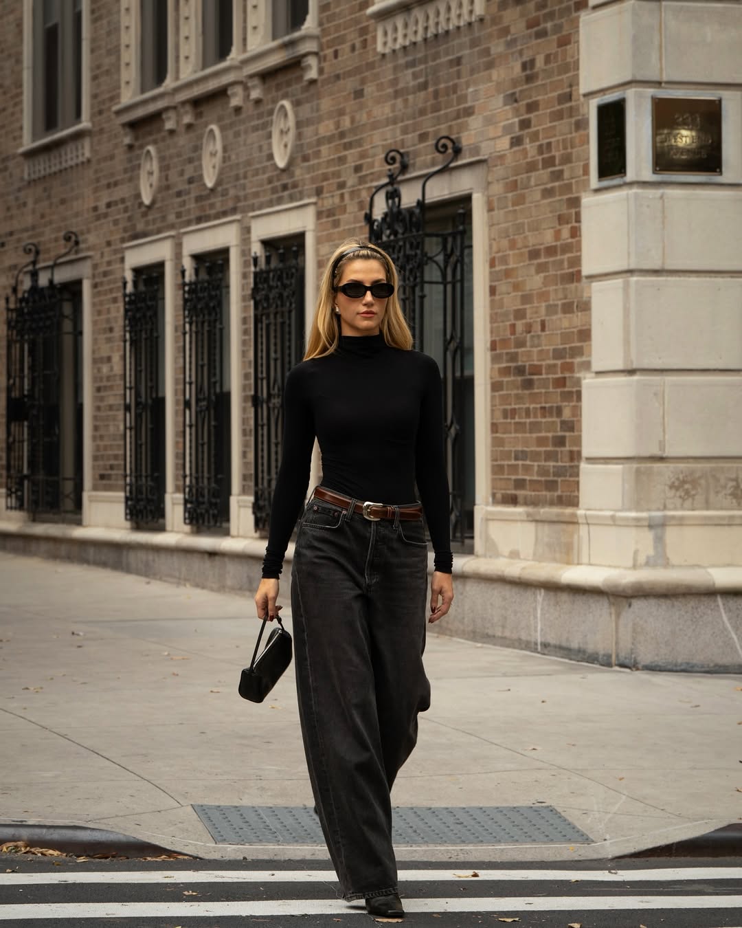 fashion influencer Cass Dimicco wearing barrel jeans with a black turtleneck top