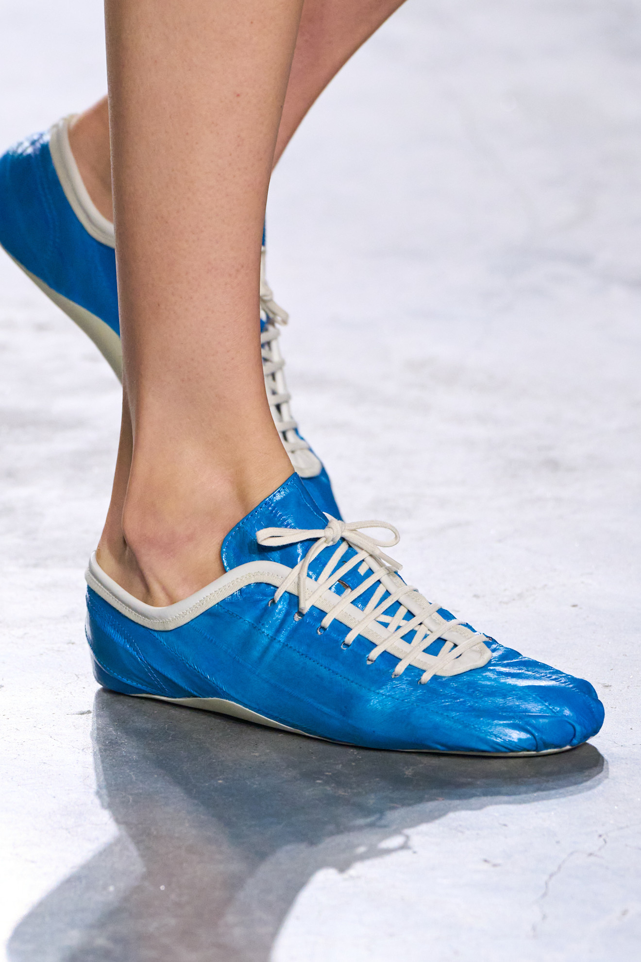 A model at the spring/summer 2026 Dries Van Noten show in Paris wearing blue eel-skin low-profile sneakers.