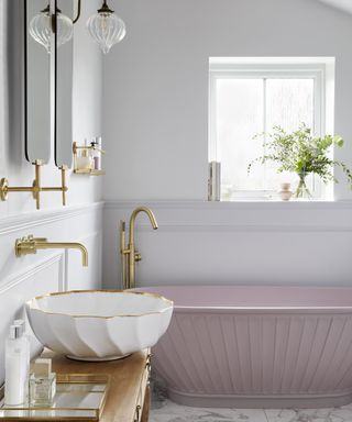 A bathroom idea with Angelica porcelain basin from London Basin Company with pink scallop detail bath