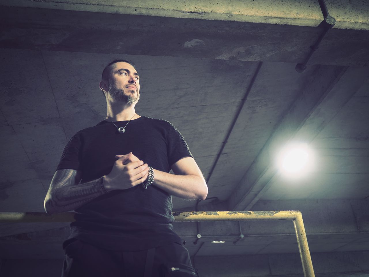 Portrait of a man in an industrial setting, taken on the OM System OM-3 with the OM System M.Zuiko 17mm f/1.8 II