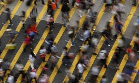 A busy street walk in Hong Kong: While China has long suffered from overpopulation, it is actually Qatar that is the world&amp;#039;s fasted-growing country.