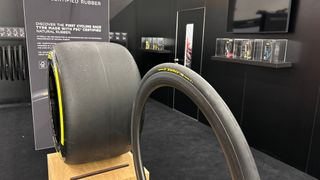 A Pirelli bike tyre stands next to a Formula 1 tyre
