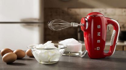 Smeg hand mixer on a kitchen counter.