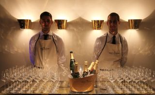 The Moët & Chandon bar with glasses and champagne in the ice bucket. Two serves stand behind the bar.
