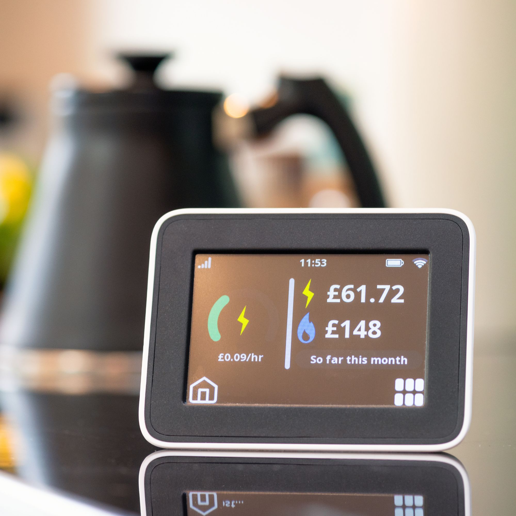 Smart energy meter on a kitchen worktop with a black and copper kettle in the background