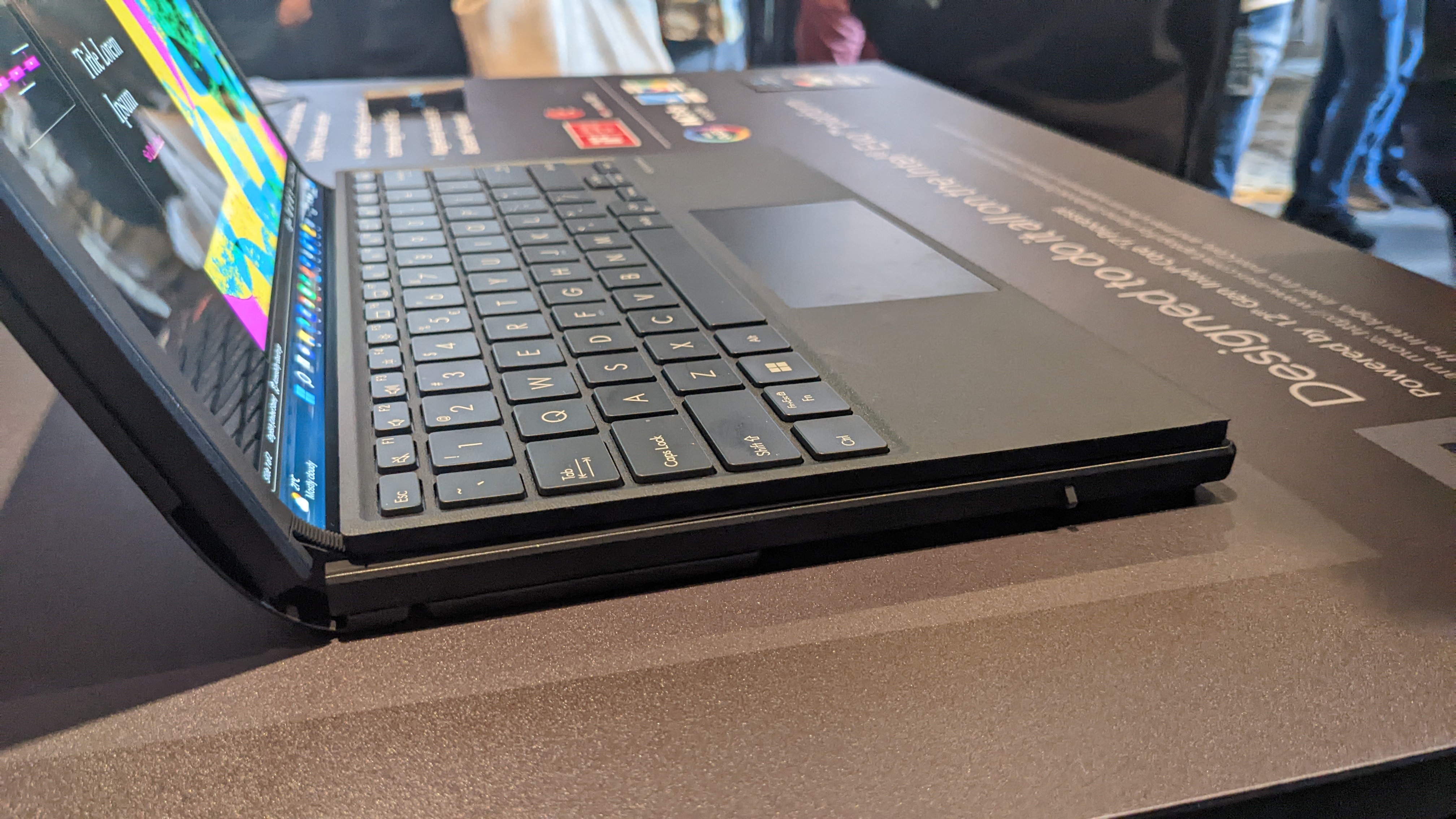 Asus Zenbook 17 Fold OLED foldable laptop on a desk at the Asus launch event.