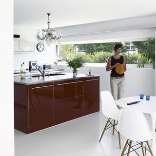 kitchen with burgundy cabinet and rounded table and chairs