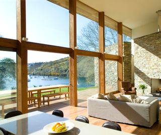 living room with large windows overlooking body of water