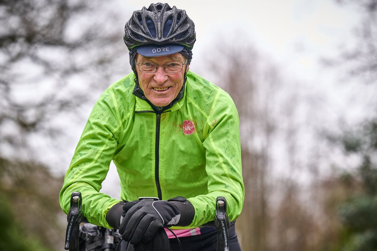 Close-up of Martin Harvey&#039;s head and shoulders. He is wet and wearing a fluoro rain jacket 