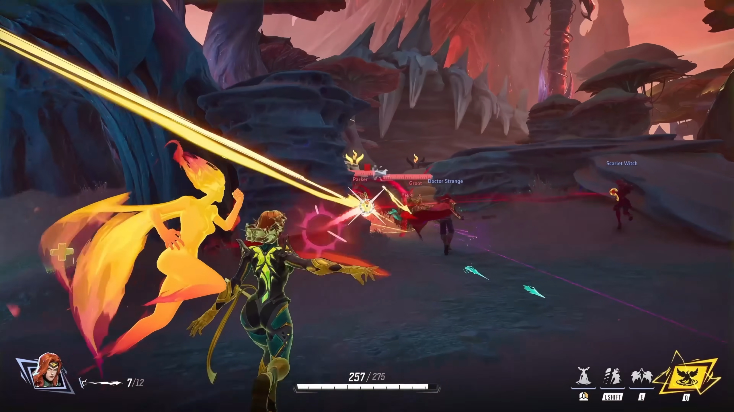 Marvel Rivals Phoenix abilities: Gameplay of Jean Grey/Phoenix firing at a group of enemies between two rocks.