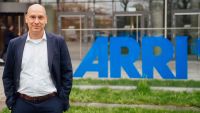 Thomas Riedel standing in front of th ARRI logo and building after his acquisition of the company.