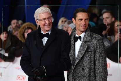 a medium shot of Paul O'Grady with husband Andre Portasio on the red carpet