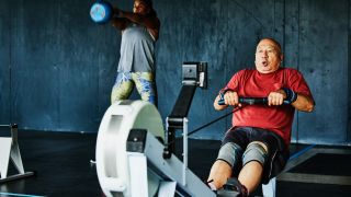 Man rowing on indoor rowing machine