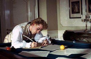 Tom Hulce as mozart composing music in the movie amadeus