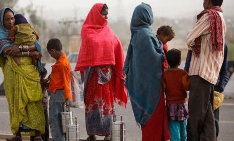 Migrant workers along with their children wait to be employed for the day in Jammu, India: Two-thirds of India&amp;#039;s 1.2 billion people live on less than $2 a day.