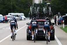 Primoz Roglic and team-mates behind team car on Stage 15 of the Vuelta a Espana 2024