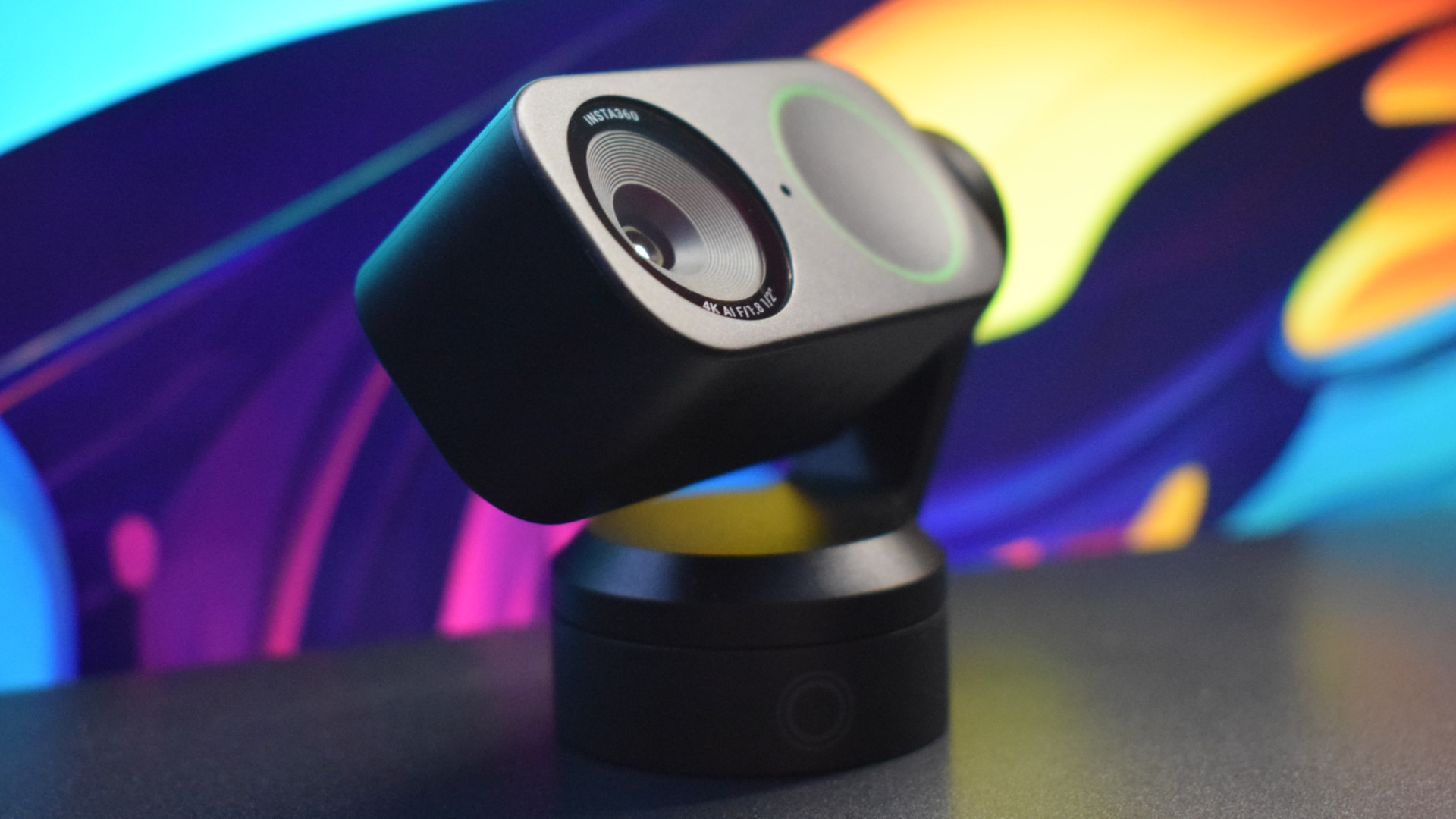 Photo of the Insta360 Link 2 4k webcam showing a 3/4 profile view of the camera without its magnetic stand tilted upward, focusing on its aperture.