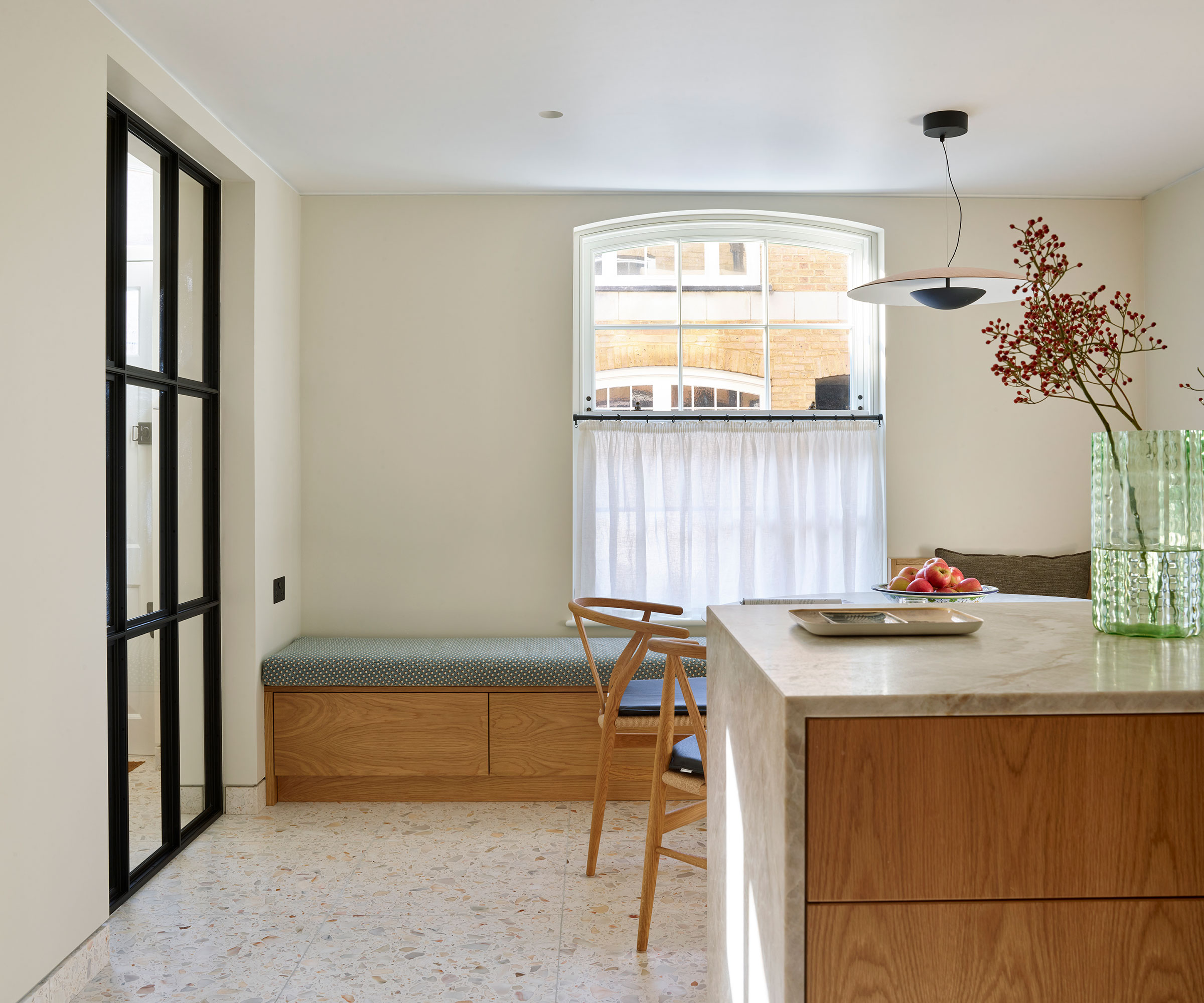 modern wooden kitchen with terrazzo floor tiles and window seat