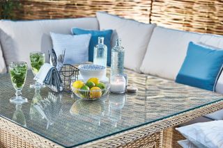 tips for choosing outdoor furniture: close-up of glass top on rattan table