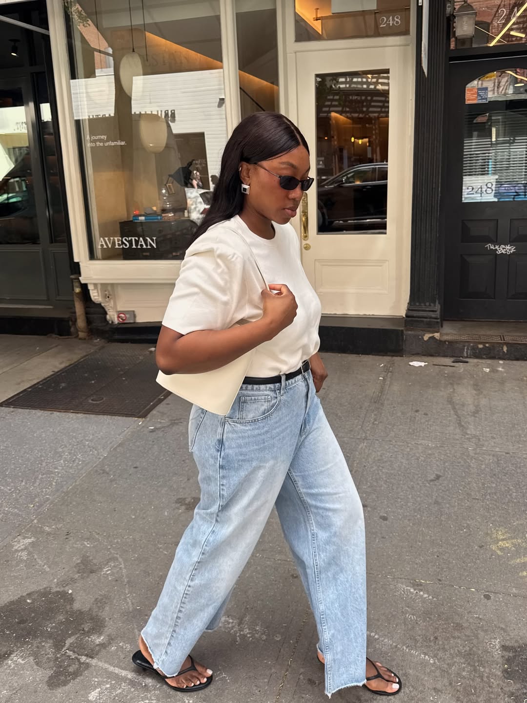 Nnenna in light-wash jeans and white t-shirt